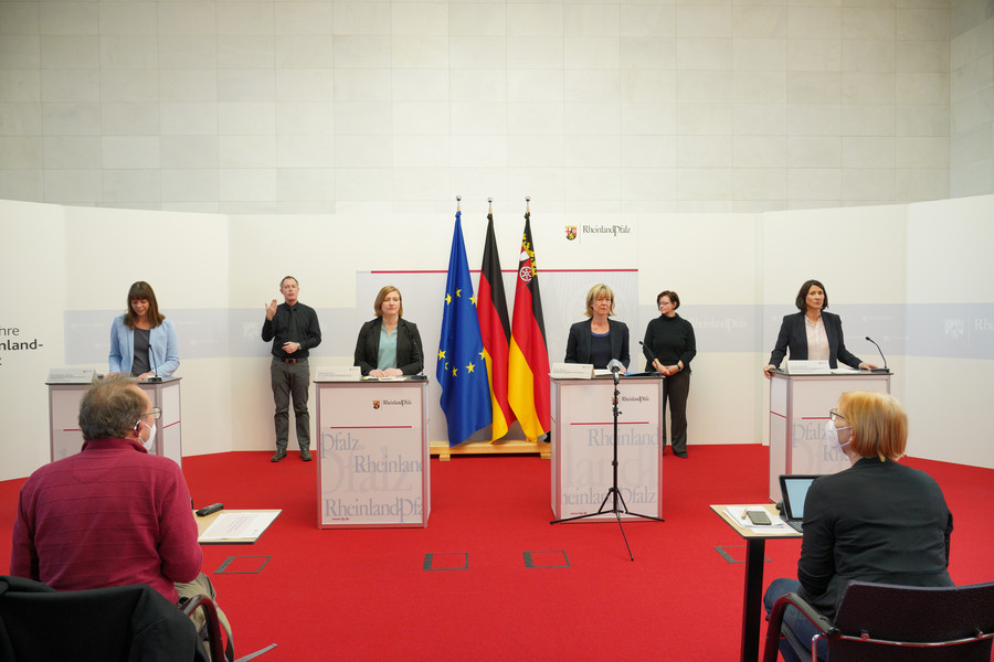 Gruppenbild Schmitt, Binz und Ahnen am Rednerpult